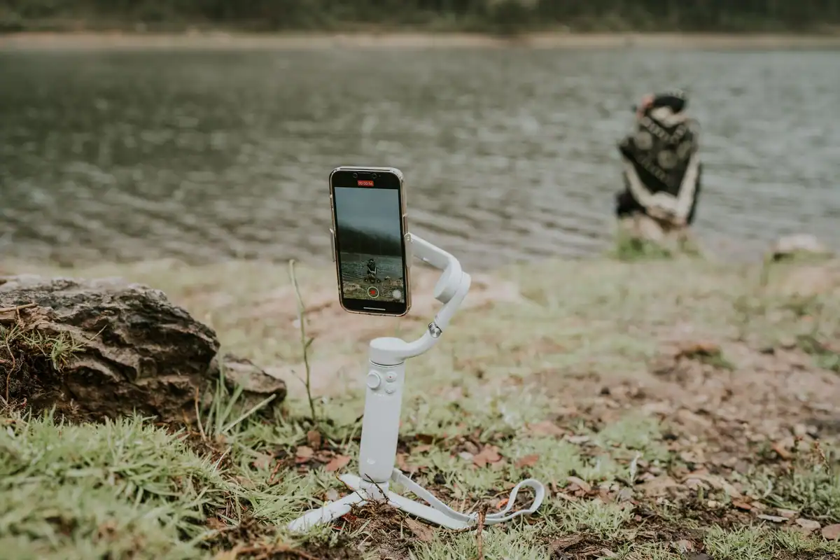 Telefon montat pe un stabilizator, care filmează un peisaj liniștit la malul unui lac